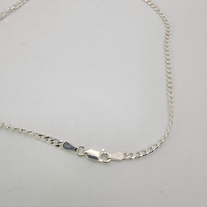 Silver curb chain with lobster clasp on white background