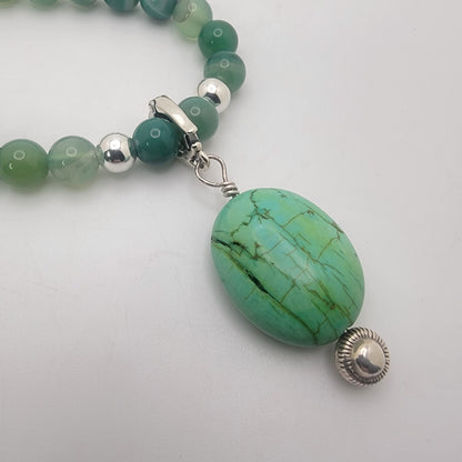 Handcrafted green agate necklace with turquoise focal bead and sterling silver accent beads.