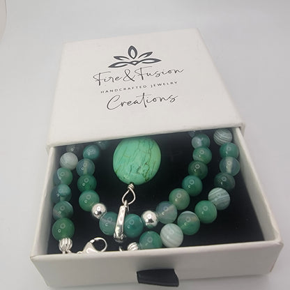 Green agate and turquoise gemstone necklace displayed in branded Fire and Fusion Creations gift box.