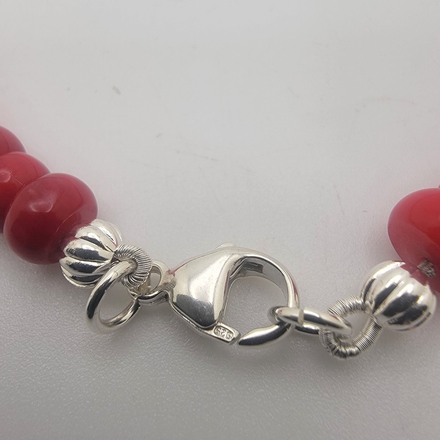 Close up of 925 sterling silver lobster clasp on white background