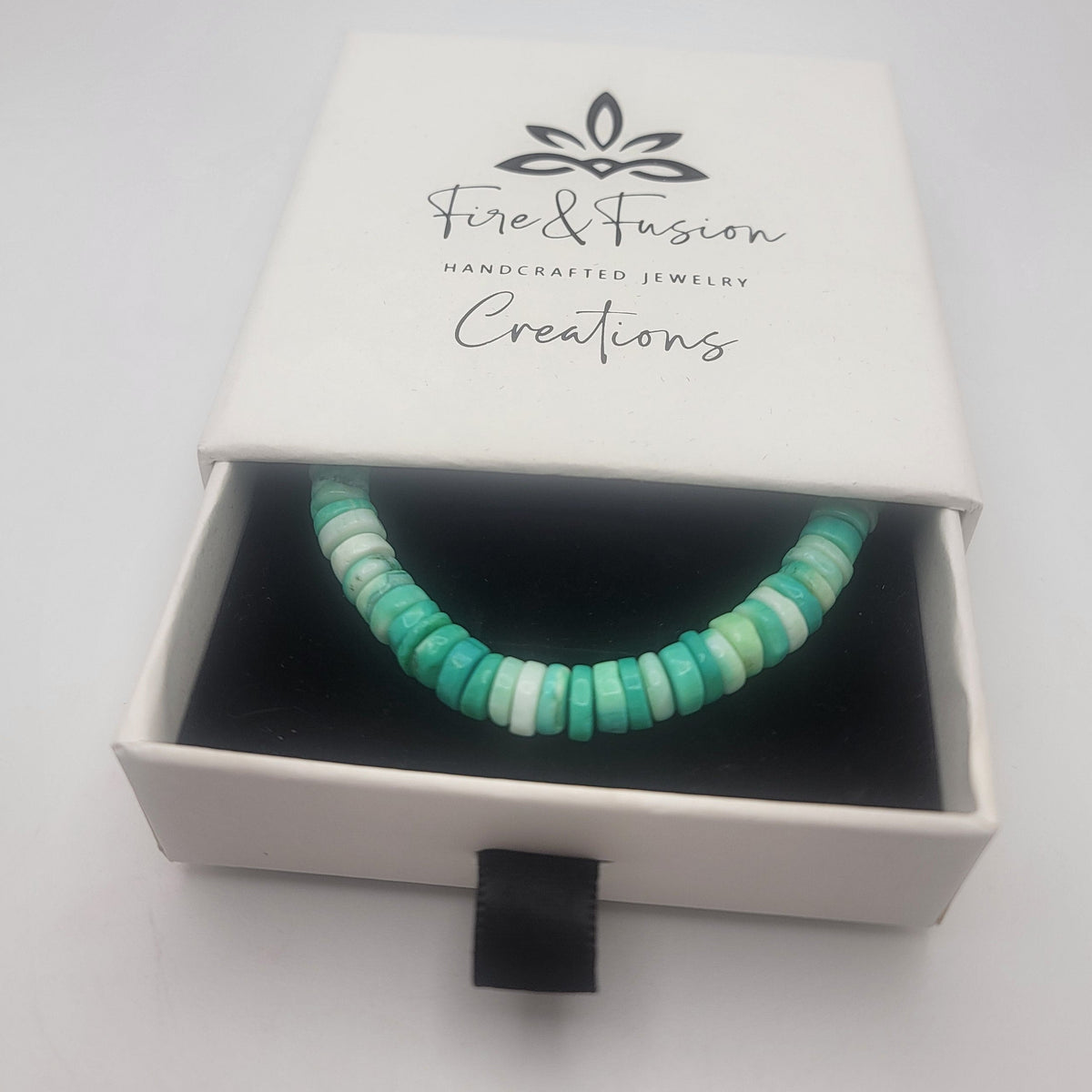 Peruvian opal beaded bracelet finished with a sterling silver lobster clasp shown in a white branded gift box on a white background.
