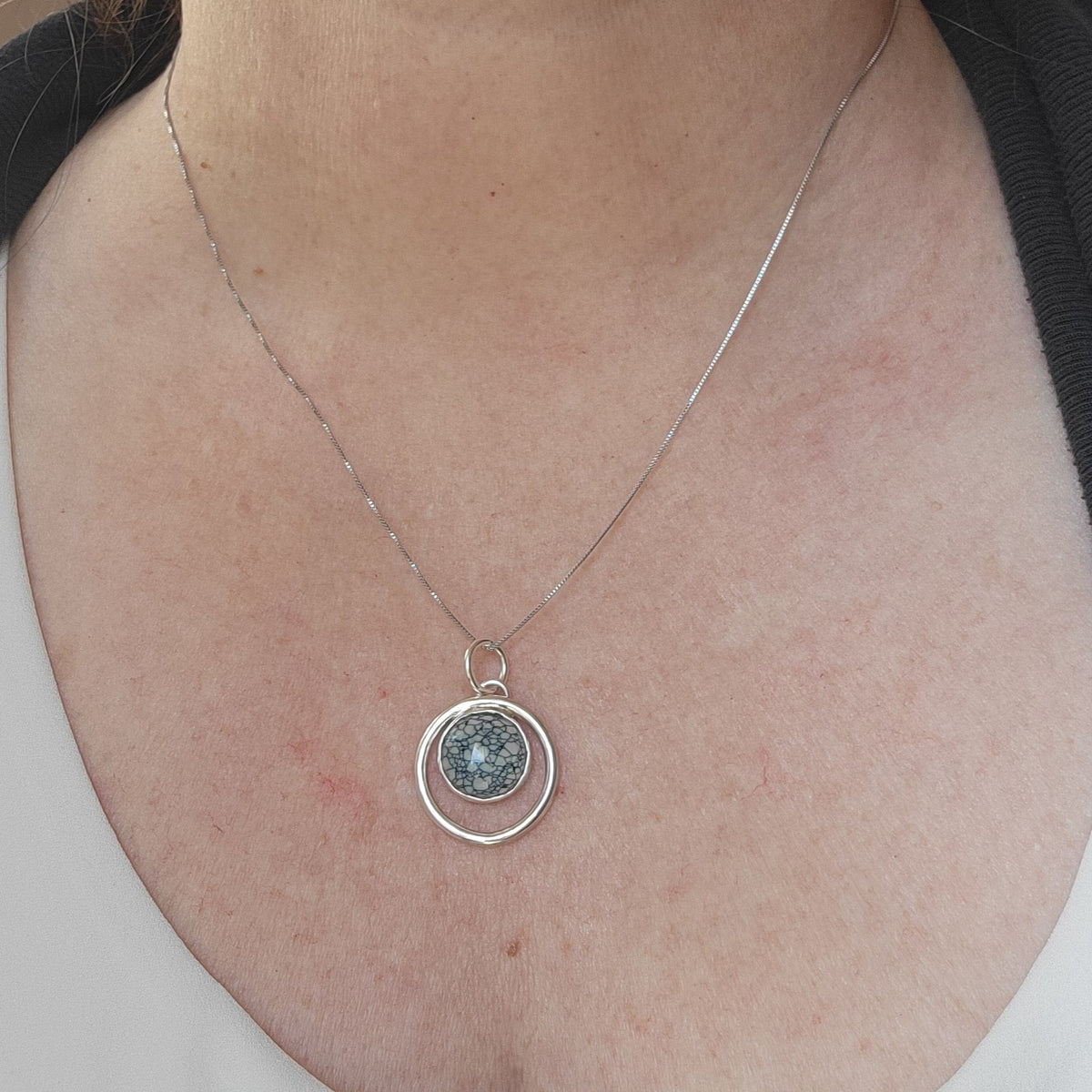 Variscite circle pendant worn on an 18-inch sterling silver chain.