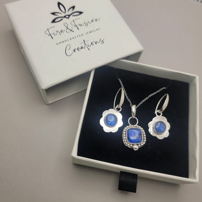 Blue kyanite necklace and earrings set in an open Fire & Fusion jewelry box.