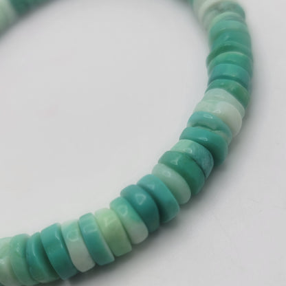Close up of Peruvian Opal beads on a white background.