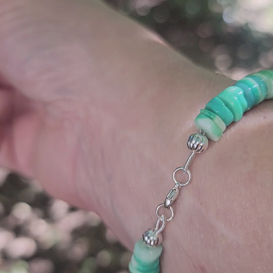 Green Peruvian opal beaded bracelet finished with a sterling silver lobster clasp worn on a wrist.