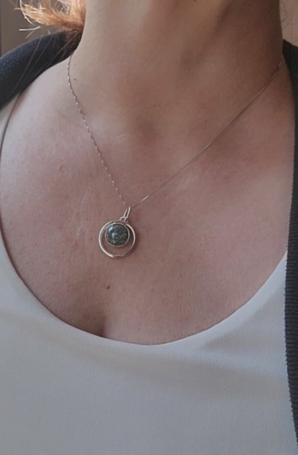 Variscite circle pendant worn on an 18-inch sterling silver chain.