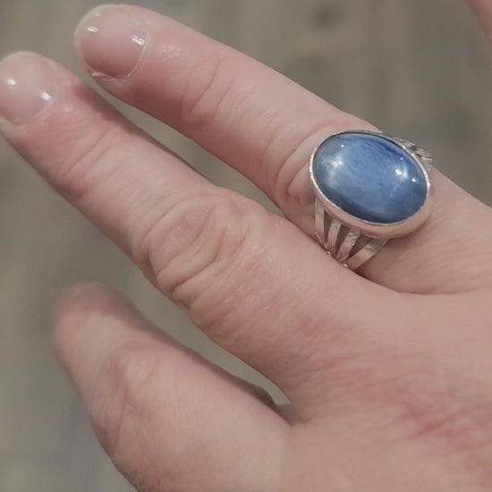 Silver ring with blue stone on a hand