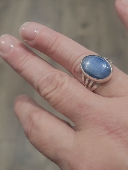 Silver ring with blue stone on a hand