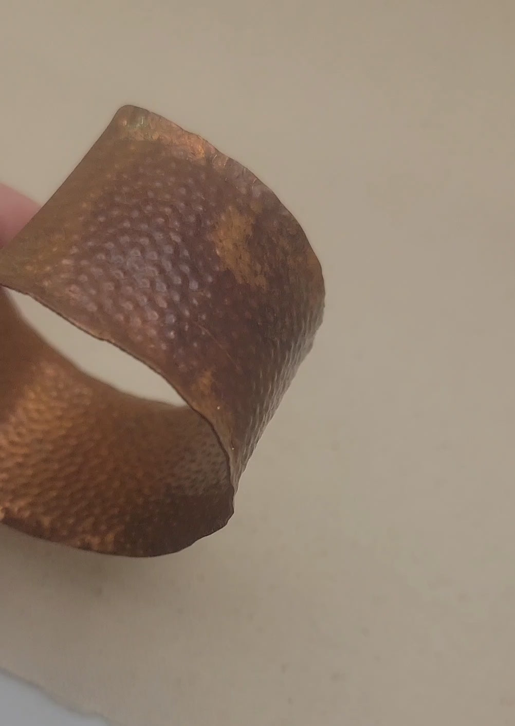 A video of a hammered and textured dimpled copper cuff bracelet being rotated to view all angles of the bracelet