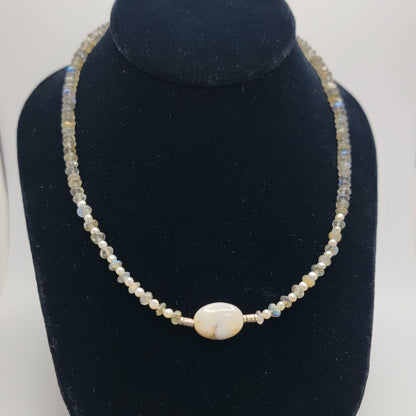 Labradorite and agate focal bead necklace on a black necklace bust on a white background