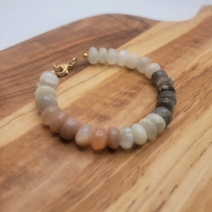 Moonstone beaded bracelet on wood board on white background