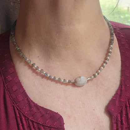 Labradorite and agate focal bead necklace worn on a person next to a window
