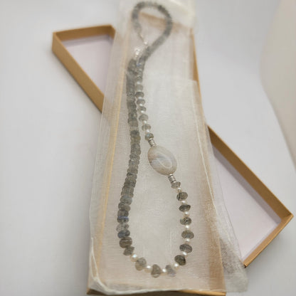 Labradorite and agate focal bead necklace in an organza bag in a cardboard gift box on a white background