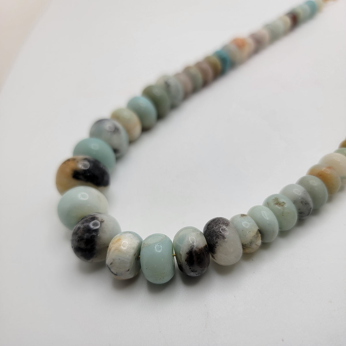 Blue and earth tone beads on a white background