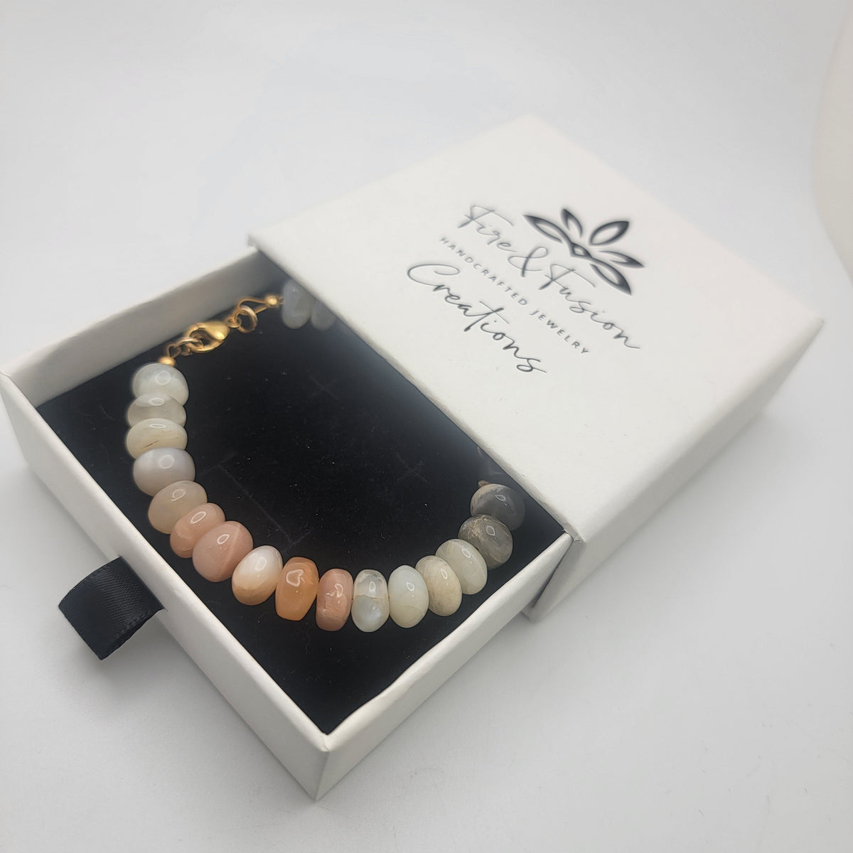 Moonstone beaded bracelet in branded gift box on white background